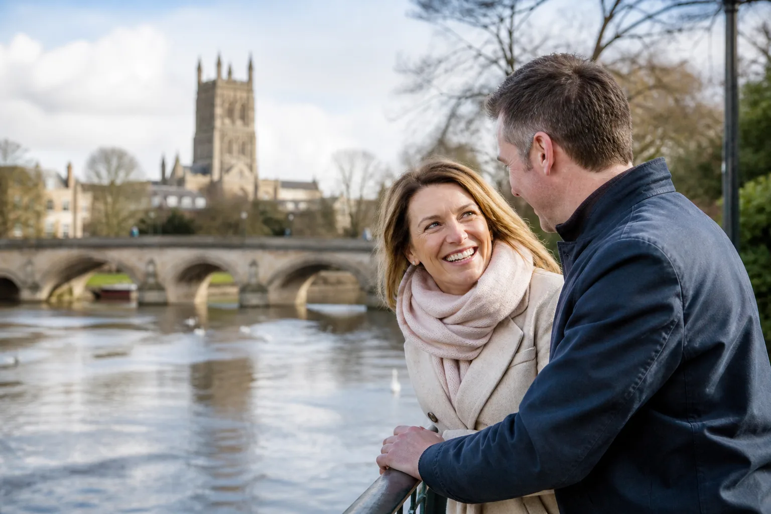 Two people talking beside the River Severn in Worcester